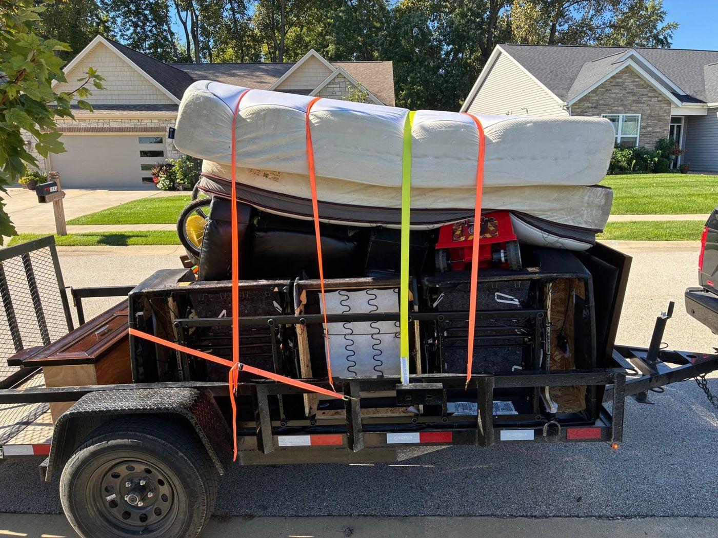 Mattresses and a box spring strapped down on a FlexHaul trailer